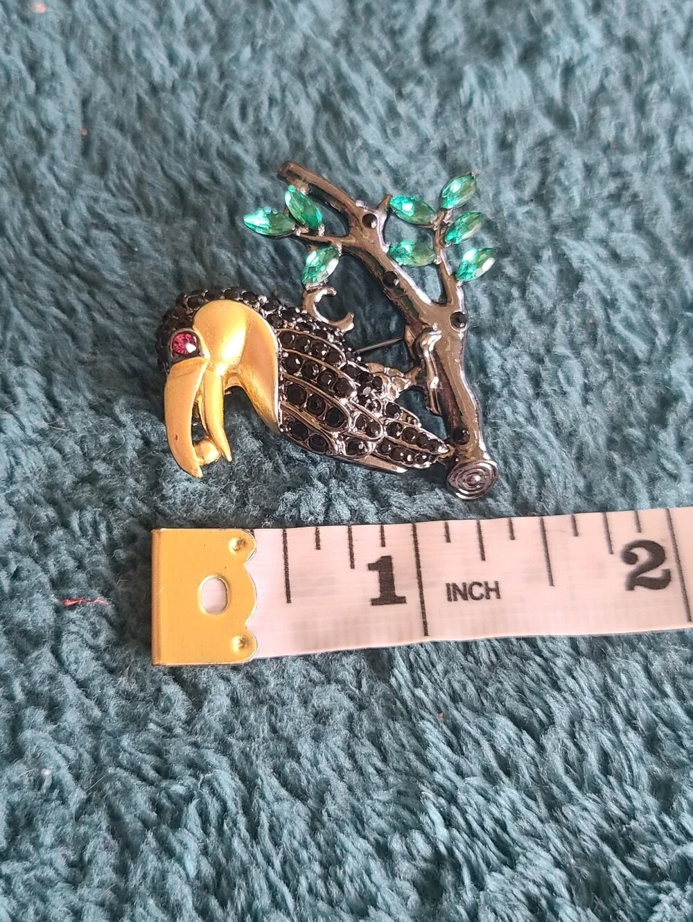 Vintage Gold-Accented Black Toucan Brooch with Green Leaves